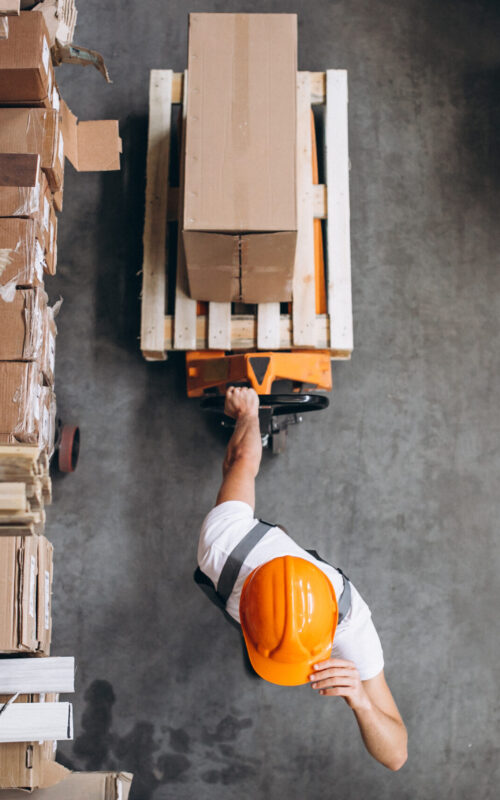 Young man working at a warehouse with boxes